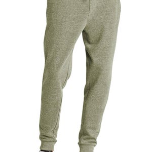 May include: Olive green sweatpants with a drawstring waist and ribbed cuffs. The pants are paired with black and white sneakers. The casual pants are made of a soft, comfortable material.