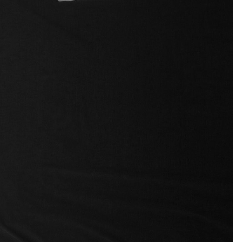 May include: A solid black fabric background.