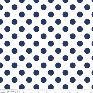 May include: White fabric with a repeating pattern of navy blue polka dots.