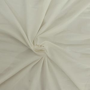 May include: A solid off-white fabric with a smooth texture, gathered at the center to create soft, radiating folds and drapes. The material displays a consistent, light cream color throughout, with natural shadows forming within the fabric pleats.