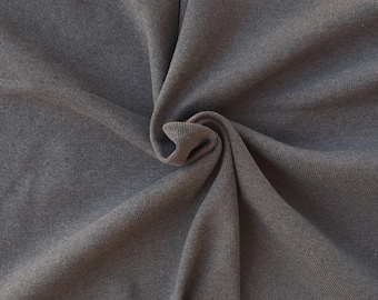 May include: Close-up of a dark gray ribbed fabric, showing the texture and folds of the material.
