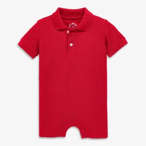 May include: A solid red baby romper with a polo collar and short sleeves. The romper has a three-button placket and snaps at the bottom. The brand name is visible on the collar.