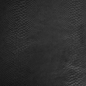 May include: Black textured fabric with a snakeskin pattern.