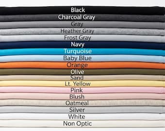 May include: A vertical stack of folded fabric pieces in various colors including black, charcoal gray, gray, heather gray, frost gray, navy, turquoise, baby blue, orange, olive, sand, light yellow, pink, blush, oatmeal, silver, white, and non-optic white.