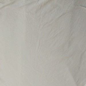 May include: A plain white fabric surface with a smooth texture.