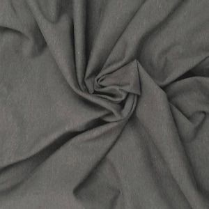 May include: A solid charcoal gray fabric with a soft, matte texture. The material is draped in loose, flowing folds, creating natural shadows and highlights across the surface that emphasize the consistent, deep gray color and fine weave.