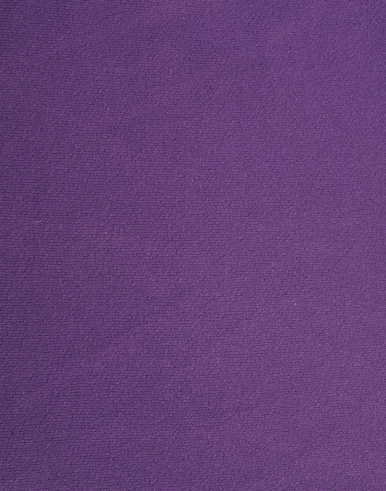 May include: A solid purple fabric with a textured surface.