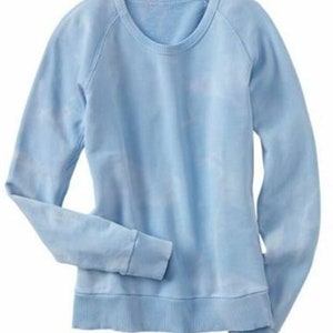May include: A light blue sweatshirt with a crew neck and long sleeves.