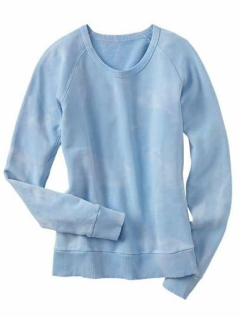 May include: A light blue sweatshirt with a crew neck and long sleeves.