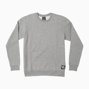 May include: A heather gray crew neck sweatshirt with long sleeves. The sweatshirt features a small black and white logo patch on the lower left side and a tag on the back of the neck. The fabric appears to be a soft, knit material.