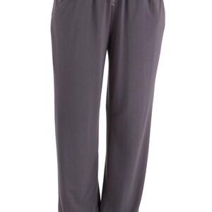 May include: Gray, loose-fitting pants with a drawstring waist and side pockets.