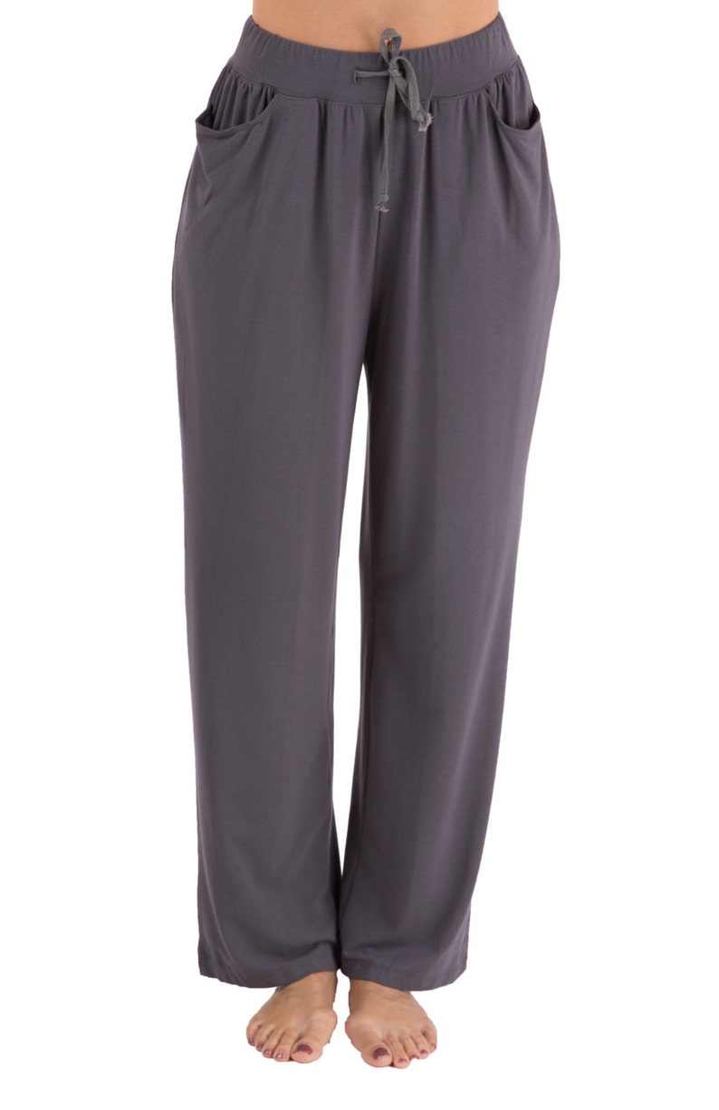 May include: Gray, loose-fitting pants with a drawstring waist and side pockets.