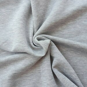 Soft sherpa fleece fabric in gray warm and fluffy, perfect for jackets, hoodies, and blankets