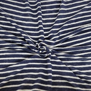 May include: White and navy blue striped fabric with a textured, linen-like appearance.