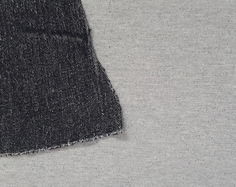 May include: Close-up of two fabric swatches, one black denim and one gray heather. The denim swatch is on top of the gray swatch.