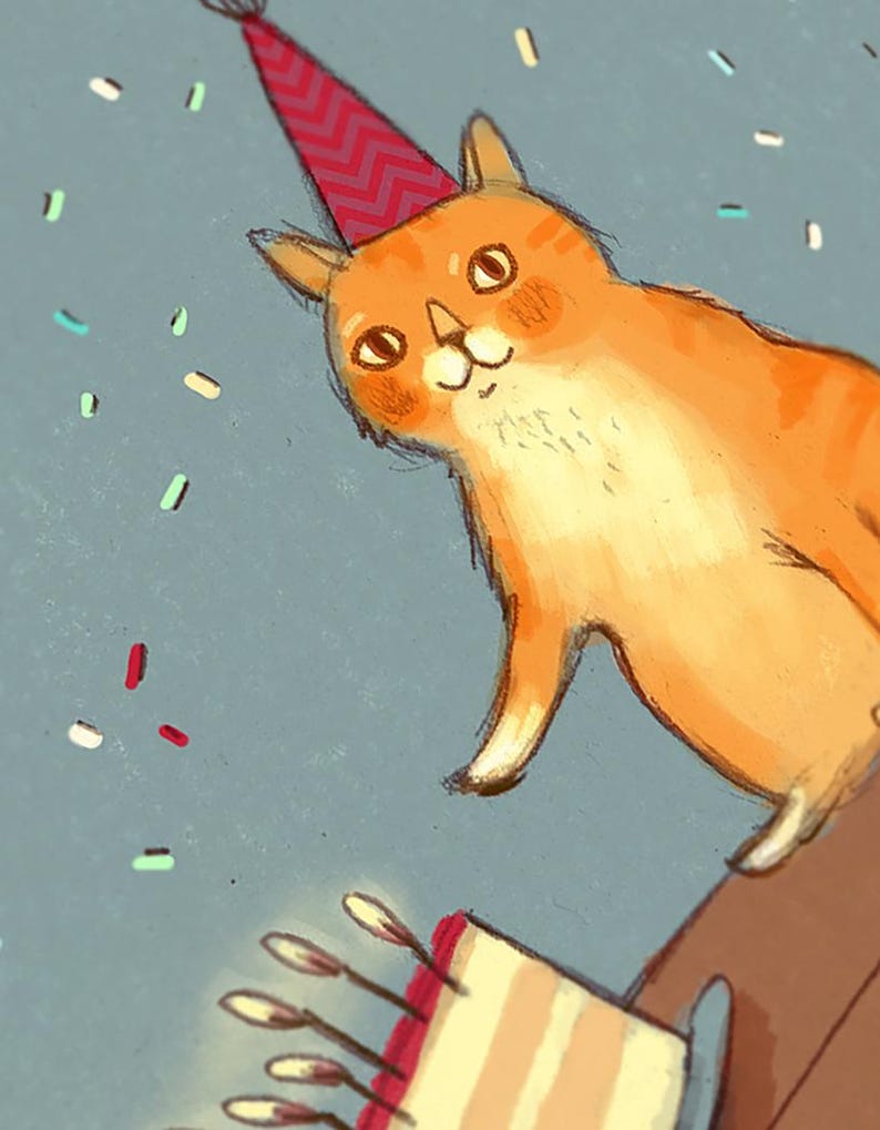 May include: A cartoon orange cat wearing a red and white party hat with a cake in the foreground. The cake has white icing and pink filling with lit candles.