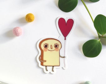 Sticker with an illustration of a cute toast holding a red heart shaped balloon