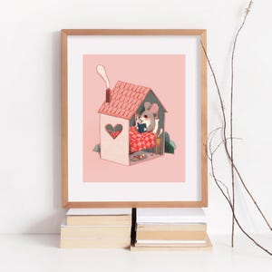 May include: A framed art print featuring a grey mouse sitting in a small house with a pink roof and a heart-shaped window. The mouse is tucked under a red and white checkered blanket, reading a blue book. A chimney with smoke sits on the roof.