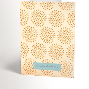 May include: A card with a repeating pattern of orange stylized flowers on a cream background. The text "illustration valerie boivin &copy;" is at the bottom of the card.