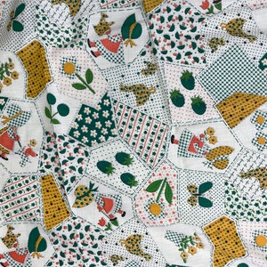 May include: White fabric with a patchwork design featuring green, yellow, and red accents. The fabric has a repeating pattern of stylised figures, flowers, and geometric shapes.