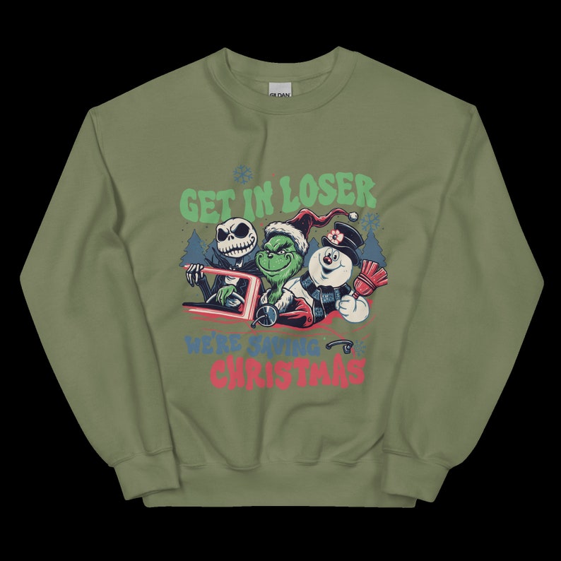 May include: Olive green sweatshirt with a graphic featuring Jack Skellington, the Grinch, and a snowman. Text reads "GET IN LOSER WE'RE SAVING CHRISTMAS" in green, red, and blue. The sweatshirt has a crew neck and long sleeves.