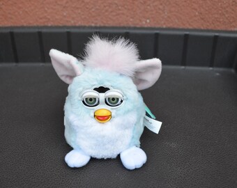 1999 Furby Babies Baby Blue/White Body with Pink Mohawk and Green/Gray Eyes and Pink Ears. Model 70-940 (Working).