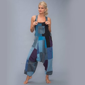 May include: A patchwork denim jumpsuit with a blue, black, and purple color scheme. The jumpsuit has a wide leg and a relaxed fit.