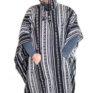 May include: A black and white hooded poncho featuring a woven pattern of vertical stripes and repeating X-shaped motifs. The garment includes a front kangaroo pocket, a drawstring hood with wooden beads, and a fringed hem along the bottom edge.
