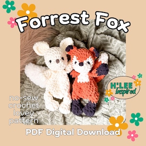 May include: Two plush crochet lovey toys, one cream-colored and one orange and white fox, featuring dark eyes and noses. The image includes the text Forrest Fox, no-sew crochet lovey pattern, PDF Digital Download, and a logo reading H'LEE Inspired.