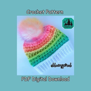 May include: A crochet pattern for a rainbow striped beanie with a white pom pom and fringe. The pattern is a digital download and is available on Etsy.