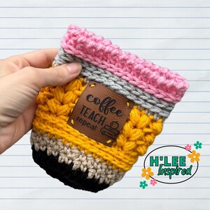 May include: Crocheted pencil-shaped coffee cup cozy with a brown leather patch that says "coffee teach repeat".