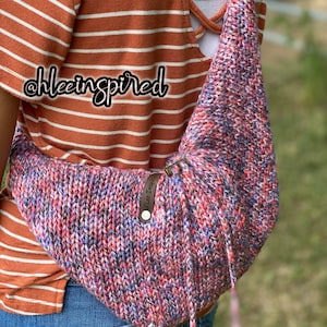 May include: A multi-colored knitted arm sling with a brown leather strap and a white tag that says "Alice Inspiring". The sling is worn over a striped orange and white shirt.