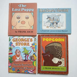 May include: Four vintage children's books with colorful illustrations. Titles include "The Last Puppy," "Mac Gooses' Grocery," "George's Store," and "Popcorn." Each book features the author Frank Asch. The "Popcorn" book is a Frank Asch Bear Story.