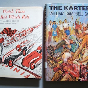 May include: Two vintage children's books. The book on the left is titled "Watch Those Red Wheels Roll" with illustrations of race cars. The book on the right is titled "The Karters" with illustrations of go-kart racing.