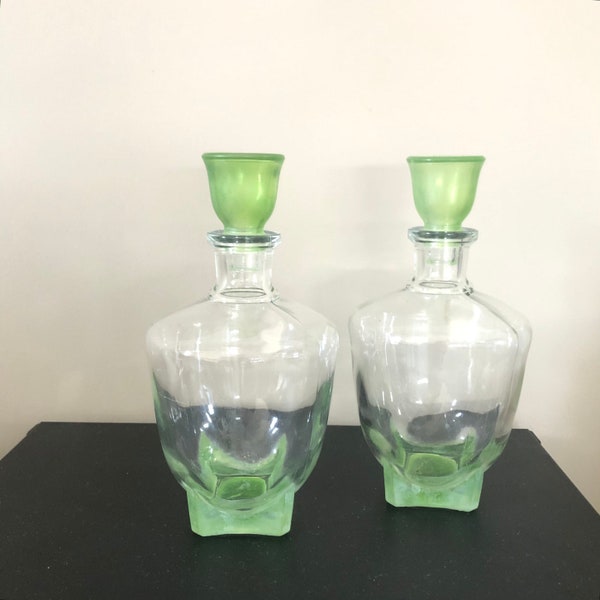 Two decanters of pressed glass, with green stopper and bottom. Square bottoms are rare, probably from the 1950s.