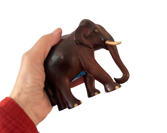Beautiful hand-carved elephant, rosewood. Tusks present and inlaid at the legs. Decorative figurine, statue foor those who love elephants.