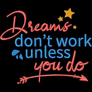 May include: Embroidered text on a black background reads "Dreams don't work unless you do." The word "Dreams" is in red script, "don't work" is in blue, and "unless you do" is in red. Gold stars and a red arrow complete the design.