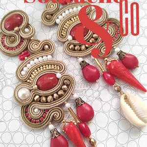 May include: An image featuring handmade Soutache jewelry and a guide. The jewelry includes earrings and decorative pieces with red, gold, white, and beige accents. The text on the image reads "Soutache & Co" and "Creative Guide with Detailed Descriptions."