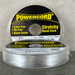 May include: A spool of clear stretchy bead cord, labeled "POWERCORD® Stretchy Bead Cord". The label also states "Latex-free, No Fray, Knots Easily", "Size: 0.8mm", "Length: 25m", and "Color: Clear".