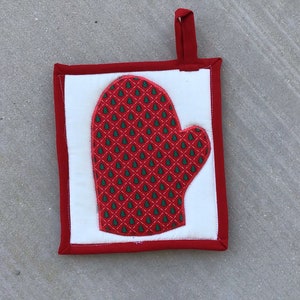 May include: Red and green Christmas tree patterned oven mitt with a white background and a red hanging loop.