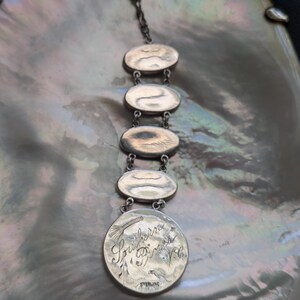 May include: A silver charm bracelet with five oval charms. The bottom charm is engraved with the text "Southern Princess Vela" and "Sterling".