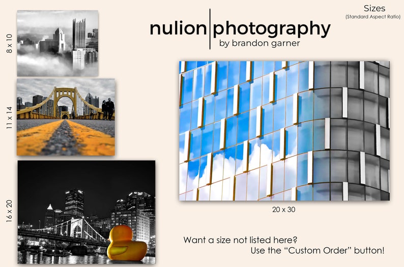 May include: A black and white photograph of a city skyline with a bridge in the foreground. The bridge is yellow and has a road going over it. The city skyline is in the background and is made up of tall buildings. The photograph is in a standard aspect ratio and is available in various sizes, including 8x10, 11x14, 16x20, and 20x30 inches.