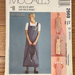 May include: McCall's sewing pattern for a dress or jumper. The pattern features a woman wearing a denim-style dress with floral embroidery. The pattern number is 2669, size G (20-22-24). The text "Cut-to-Fit" is also visible.