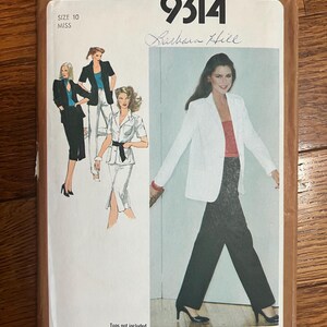 May include: Simplicity sewing pattern number 9314 for a blazer, designed by Barbara Hill. The pattern is for size 10 miss and includes instructions for making a white blazer with black pants. The pattern is on a brown background with a white border.