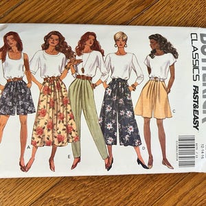 May include: A vintage Butterick sewing pattern featuring illustrations of women's clothing designs. The designs include shorts, skirts, and pants, with floral and solid color options. The pattern is labeled "Classics Fast & Easy" and includes size information.