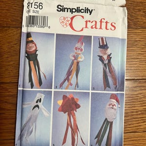 May include: Simplicity Crafts pattern number 2156 for making six different windsock designs. The designs include a ghost, a Santa, a leprechaun, a bunny, a star, and Uncle Sam. The pattern is designed by Wendy Everett.