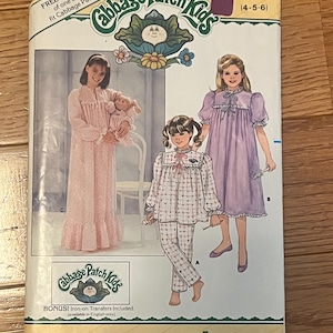 May include: A vintage Butterick sewing pattern for Cabbage Patch Kids outfits. The pattern features illustrations of children in pajamas and nightgowns. The pattern size is 4-5-6. Includes iron-on transfers. The cover has the text "FREE PATTERN" and "BONUS! Iron-on Transfers Included."