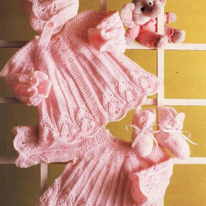 May include: A pink knitted baby outfit with a matching hat and booties. The outfit features a delicate leaf pattern and a button closure.