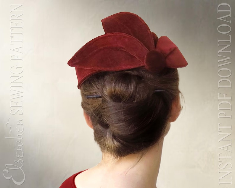 May include: A deep red velvet hat featuring a structured, multi-layered petal design and a central circular accent. The text "Elsechen SEWING PATTERN" and "INSTANT PDF DOWNLOAD" is visible on the left and right sides of the image.