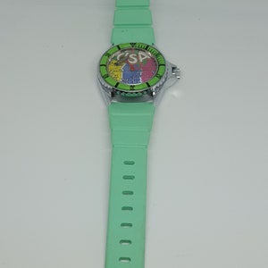 May include: A green wristwatch with a colorful face and a green rubber band.